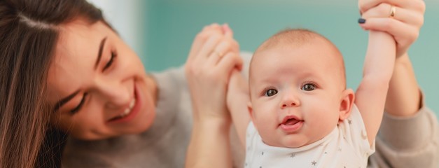 mother and her baby. a beautiful woman with dark hair and attractive facial features holds on her ha