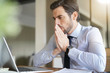 © goodluz - Stressed handsome business man looking at laptop in office