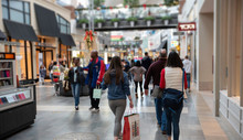 Shoppers Walk Through A Crowded Mall A Few Days Before Christmas