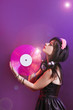 © NataliAlba - dj headphone equipment disco girl party retro vintage ultraviolet mixer young woman vinyl glamor valentine's day plastic pink proton purple