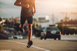 © sutadimages - Athlete runner feet running on road, Jogging concept in the city
