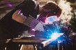 Worker is welding using mig mag welder constructions in the factory