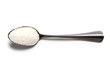 Teaspoon of sugar on a white background isolation top view