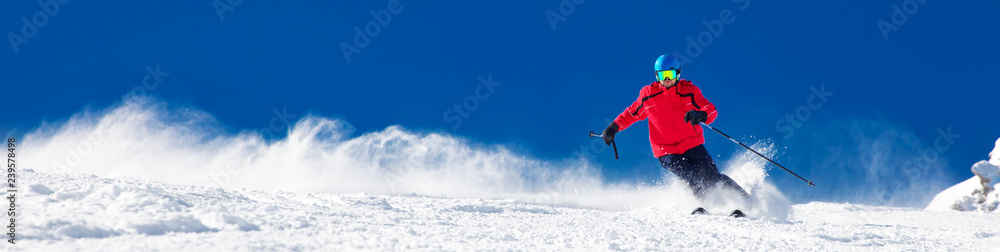 Man skiing on the prepared slope with fresh new powder snow - obrazy, fototapety, plakaty 