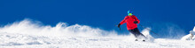 Man Skiing On The Prepared Slope With Fresh New Powder Snow