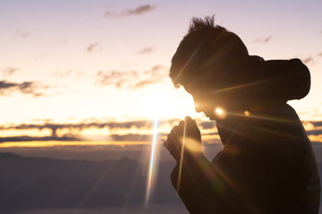 Silhouette of christian man hand praying,spirituality and religion,man praying to god. Christianity concept.