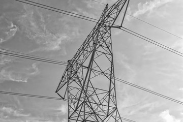 Black and white power transmission tower with lines