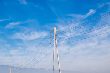 Electricity power lines and blue sky and clouds