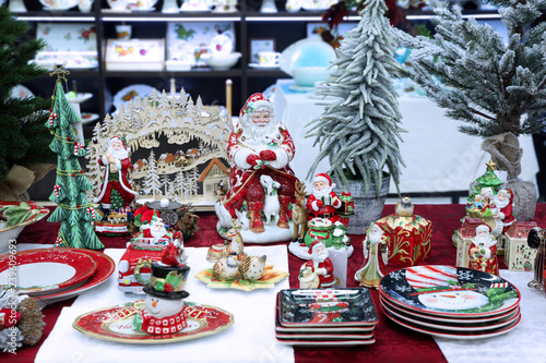 Fotografie, Obraz Colorful Christmas Souvenirs, decorative statues of Santa Claus, snowman, plates