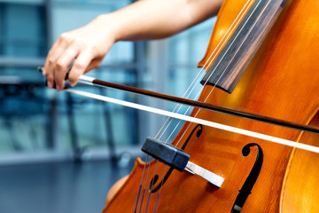 Close up of cello with bow in hands