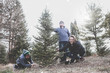 © soupstock - Family cutting a tree at a Christmas tree farm