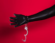 © serikbaib - handcuffed fetish hands in latex