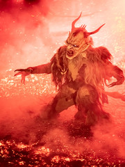 Fire red. In the flames. Krampus, Christmas devils