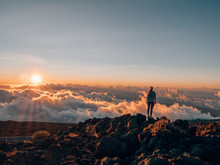 A Girl With Wanderlust Standing On Haleakalā And Watching The Sunset