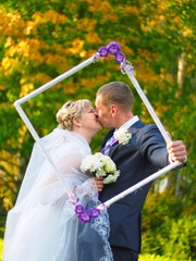 Wall Mural - Wedding in the fall, the couple kissing