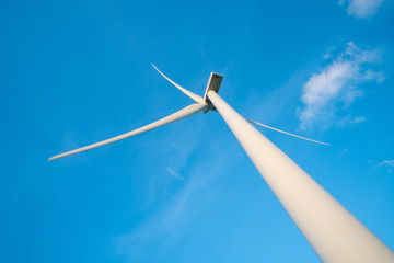 Wind turbine farm or windmill on blue sky. Turbine green energy electricity or wind turbine in a green field - Energy Production with clean and Renewable Energy. Phan Rang, Vietnam