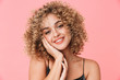 © Drobot Dean - Portrait closeup of gorgeous curly woman 20s wearing dress smiling while standing, isolated over pink background