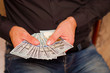 © yra1111 - a man holds dollars in his hands