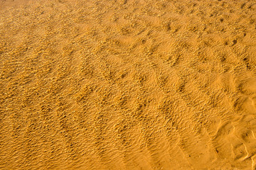 shallow surf with sand of a beach with patterns