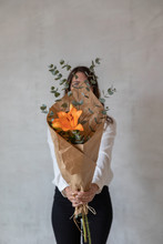 Young Girl Holding A Bouquet Of Flowers