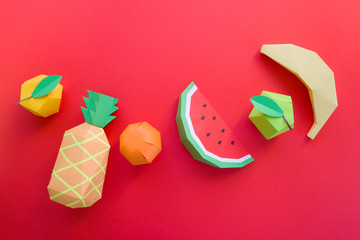 exotic fruits made of paper on red background