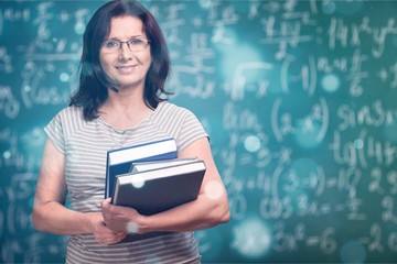 Wall Mural - Mature woman teacher with books on background