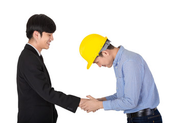 The young engineer in yellow helmet shaking hand with his boss. The handsome CEO hold co worker hand to thank you for complete new project. Portrait of business concept on isolated white background.