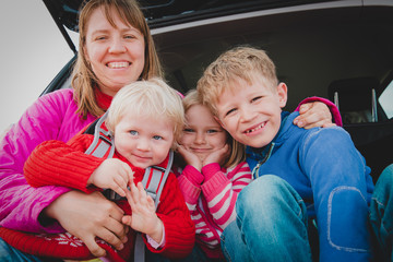 happy mother with kids enjoy travel by car on road