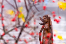 Wooden Mermaid With A Colourful Red And Yellow Leaves In Foreground
