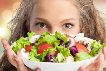 Canvas Print - Attractive caucasian smiling woman with salad  isolated