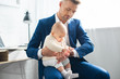 © LIGHTFIELD STUDIOS - cute baby touching watch of handsome father in suit
