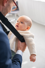 Wall Mural - selective focus of infant daughter looking at father