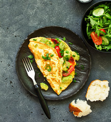 Wall Mural - omelet with avocado, tomatoes and cheese for breakfast.