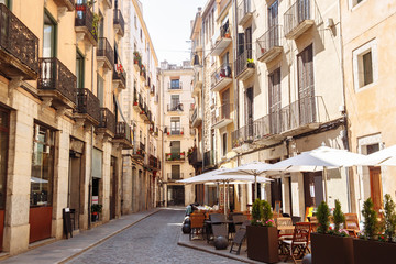 Street view with cafes in the old town in Girona city