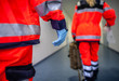 © filmbildfabrik - German paramedic runs in a floor to an accident