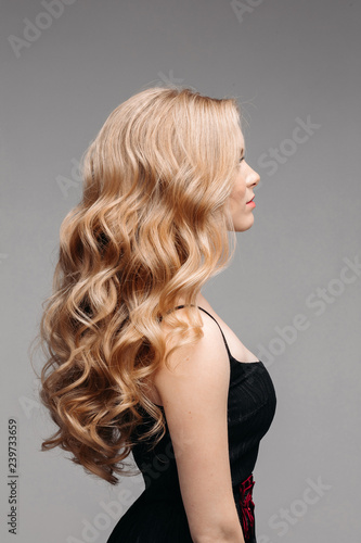 Back View Of Unrecognizable Woman In Black With Volumous Blonde