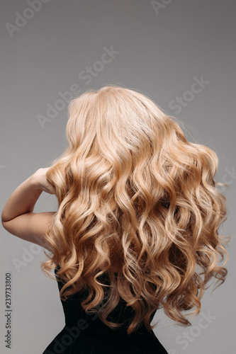 Portrait Of Beautiful Young Blond Woman With Long Wavy Hair Back