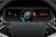 © scharfsinn86 - Electric car dashboard display closeup. Speedometer, battery level and efficiency indicator