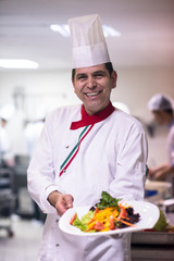 Chef showing a plate of tasty meal