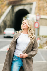 Wall Mural - outdoor portrait of fashion woman wearing long beige cardigan