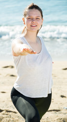 Wall Mural - Portrait of sportswoman which is stretching in white T-shirt