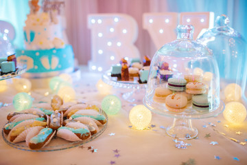 Wall Mural - Delicious wedding reception candy bar dessert table full with cakes, sweets, macaroons, eclairs and other types of bakery