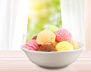 Wall Mural - Ice cream scoops in bowl on white background