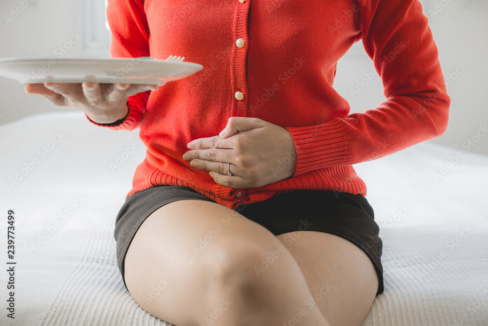 Digestion problems,Woman with stomach pain after eating,NCDs Concept - obrazy, fototapety, plakaty 