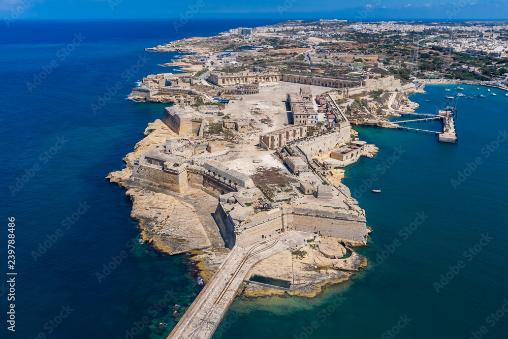 Fort Ricasoli aerial view. Island of Malta from above. Bastioned fort built by the Order of Saint John in Kalkara, Malta. Gallows' Point, north shore of Rinella Bay, entrance to the Grand Harbour. - obrazy, fototapety, plakaty 