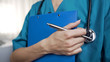 Young nurse ready to writedown patient information into hospital form, anamnesis