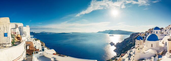 Fototapete - Churches in Oia, Santorini island in Greece, on a sunny day. Panorama view.