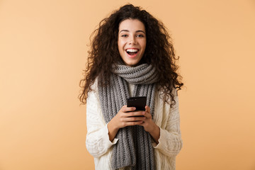 Wall Mural - Cheerful young woman wearing winter scarf