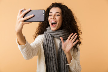 Wall Mural - Cheerful young woman wearing winter scarf