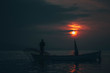 © toghrul - Sun goes down while fisherman throws his fishnet to collect fishes